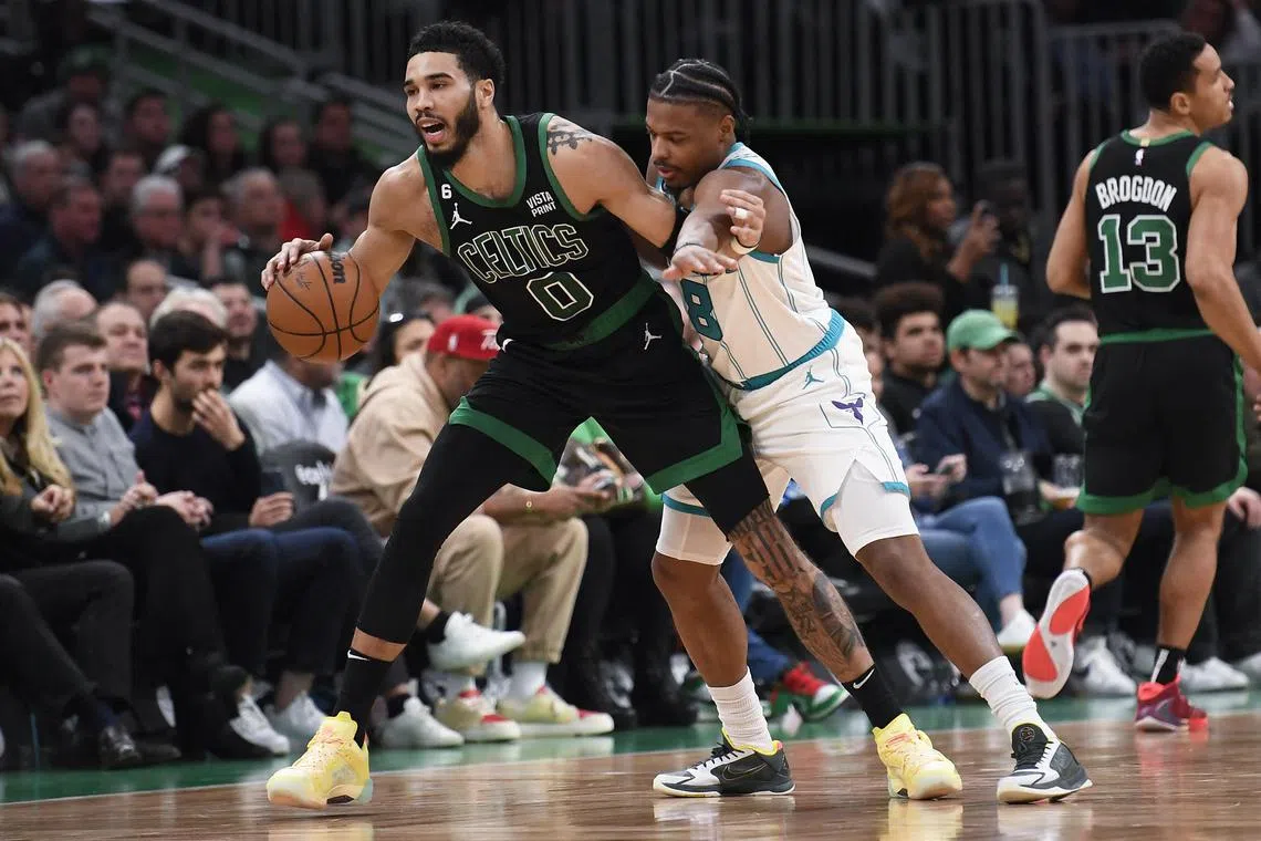 Boston Celtics forward Jayson Tatum controlling the ball against Charlotte Hornets guard Dennis Smith Jr during the first half at TD Garden.