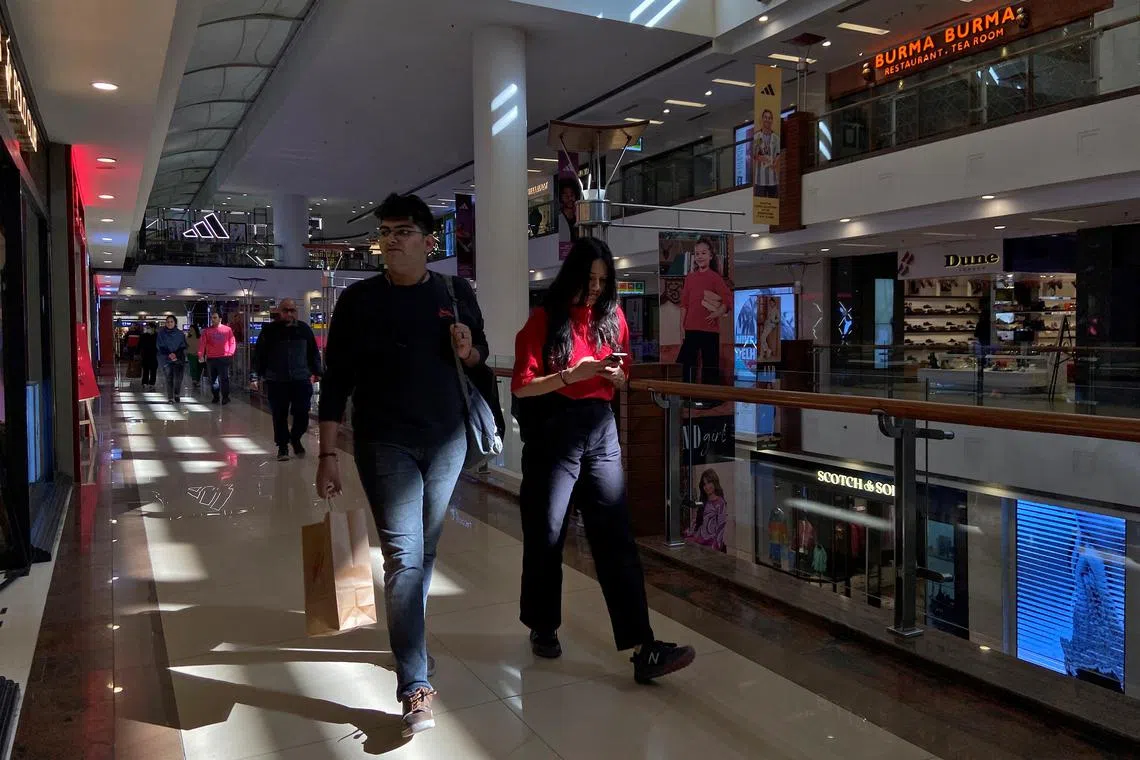 Shoppers walk inside a shopping mall in New Delhi, India, December 14, 2022. REUTERS/Anushree Fadnavis/File Photo