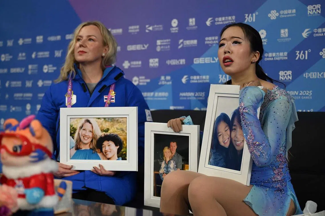 Thailand’s Teekhree Silpa-Archa (right) holding the photos of US figure skaters who passed away in a plane crash as she waits for her results in the women’s single skating free skating event during the Harbin 2025 Asian Winter Games in Harbin, northeast China's Heilongjiang province on Feb 13, 2025. 