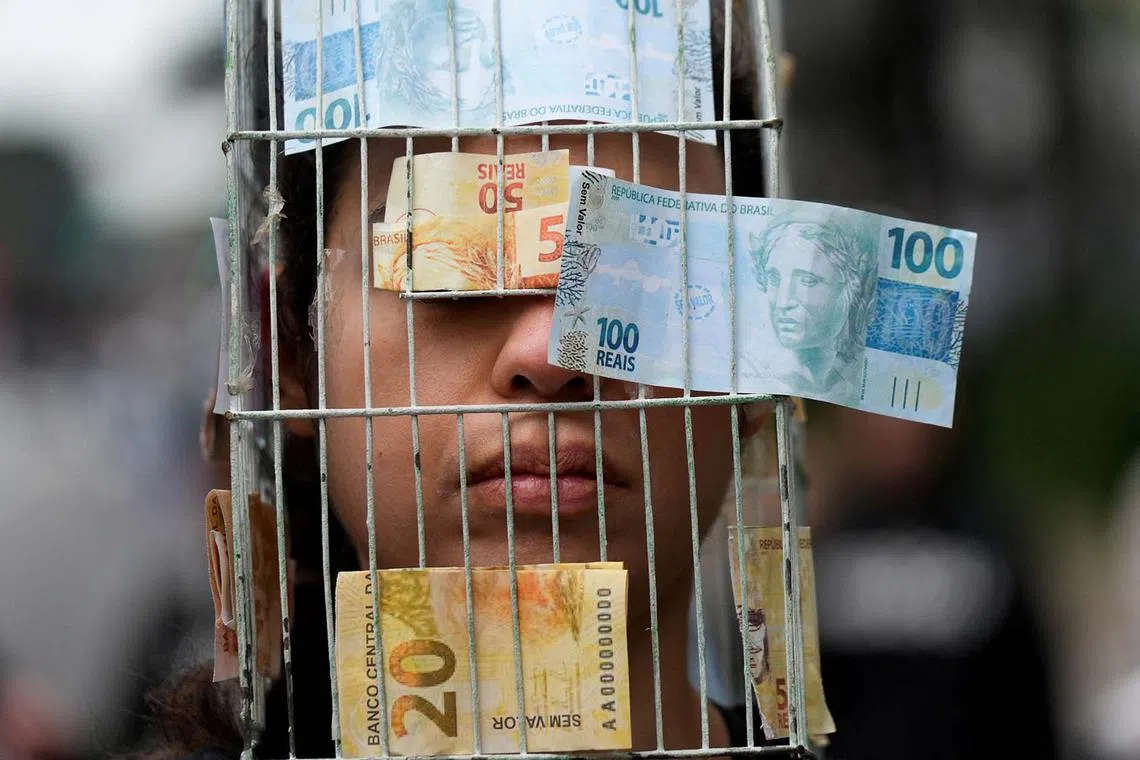 A person wears a costume representing a cage with banknotes attached to it, as animal protection activists protest against the export of live animals, at Paulista Avenue, in Sao Paulo, Brazil June 15, 2025. REUTERS/Alexandre Meneghini TPX IMAGES OF THE DAY