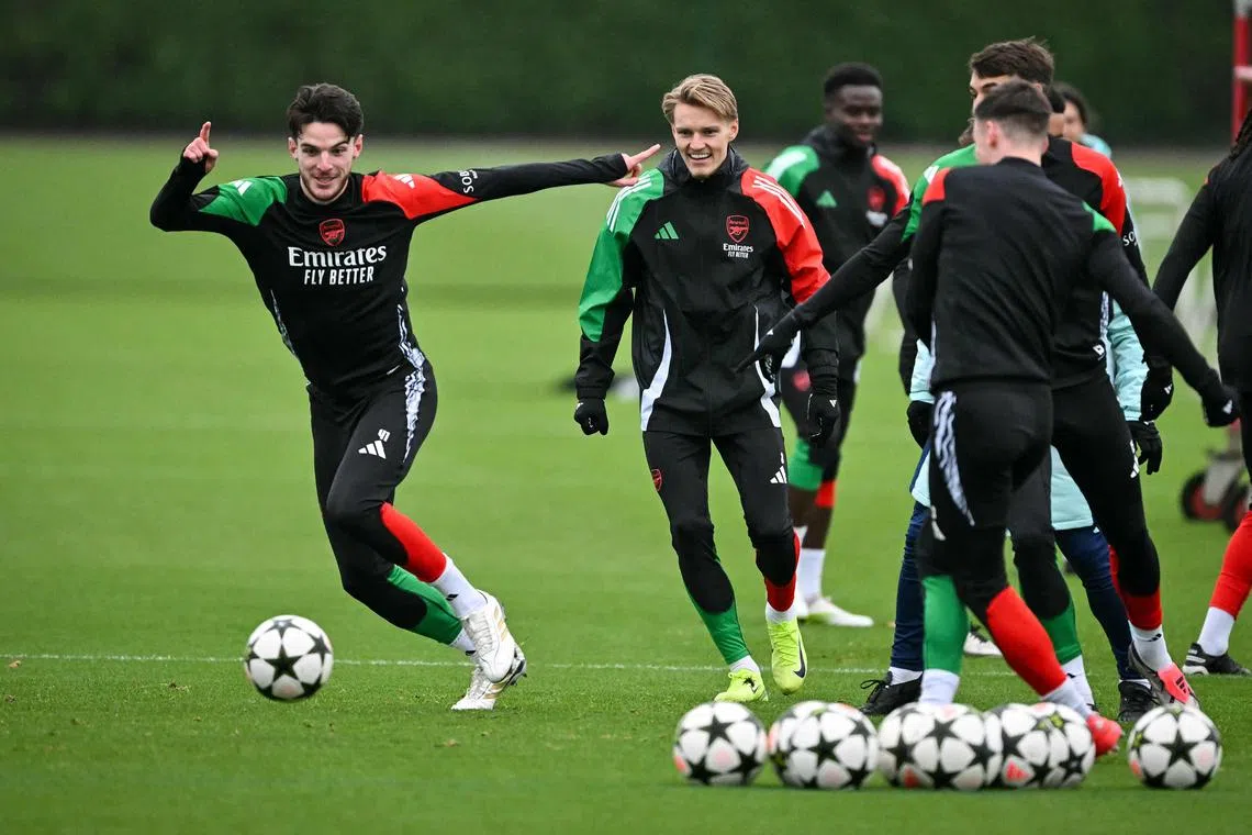 Arsenal's Declan Rice (left) and Martin Odegaard (centre) taking part in a training session on Dec 10.