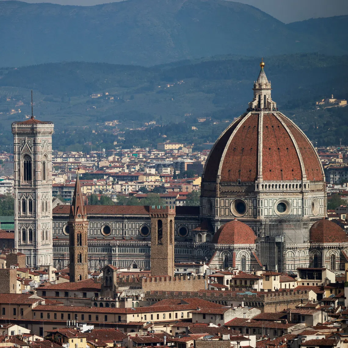 FILE PHOTO: Brunelleschi's Dome and Giotto's Campanile of the Cathedral of Saint Mary of the Flower (Cattedrale di Santa Maria del Fiore) are pictured from a panoramic point of Florence, in Tuscany region, Italy, April 15, 2024. REUTERS/Yara Nardi/File Photo