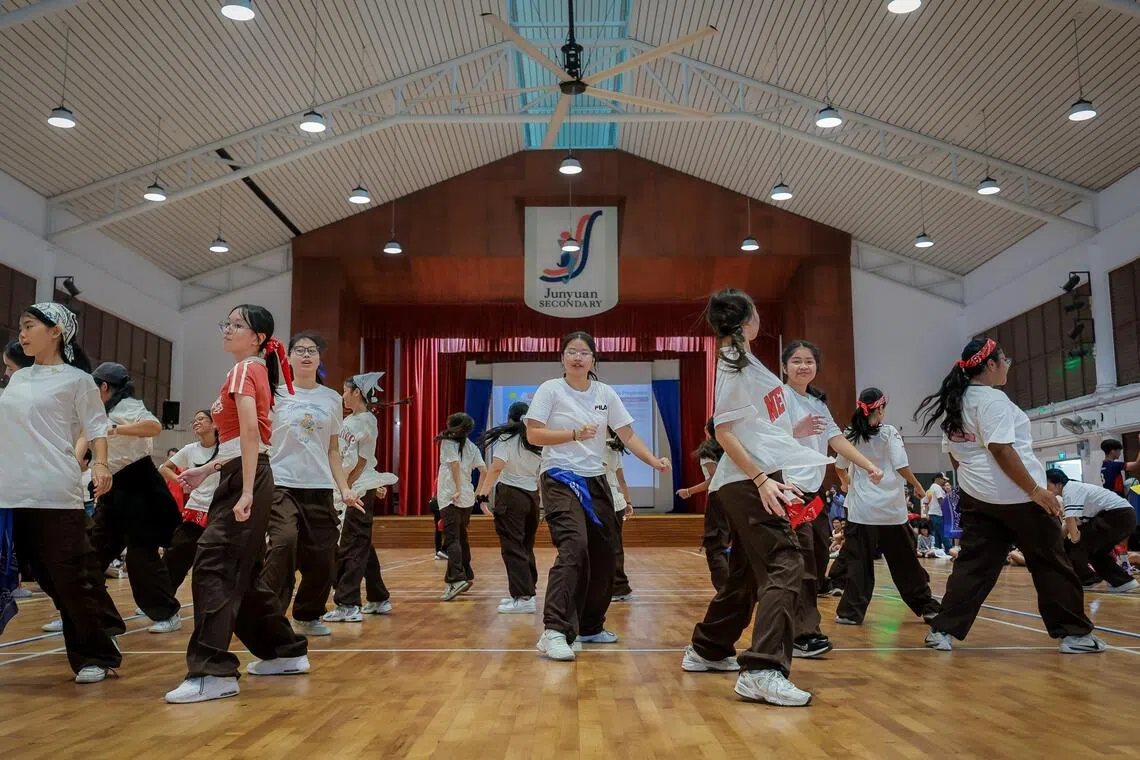 Students from the Modern Dance CCA (co-curricular activity) performing at the open house at Junyuan Secondary School on Nov 22, 2025.  Open houses, which give visitors an idea of the school's learning environment and culture, can be useful in helping post-PSLE students find a secondary school that is a good fit for them.