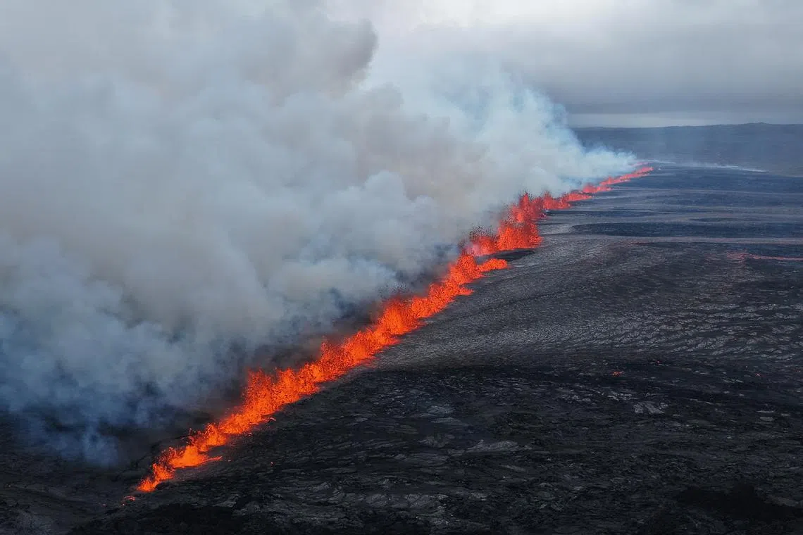 Lava and smoke erupting from a volcano near Grindavik on the Icelandic peninsula of Reykjanes on July 16.