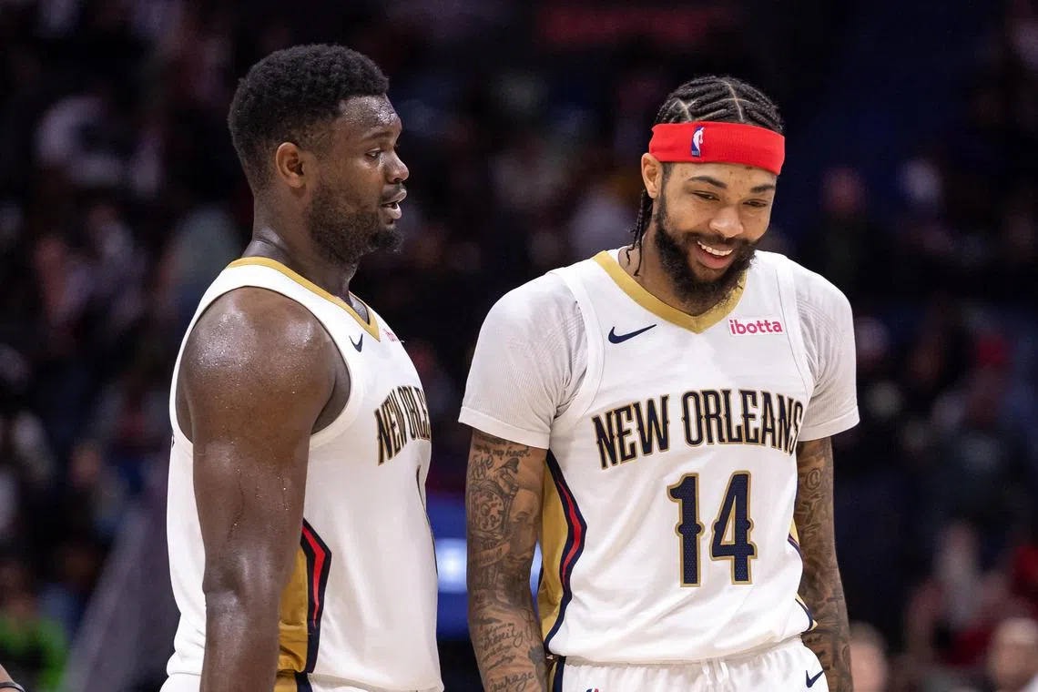 New Orleans Pelicans forward Zion Williamson (left) and forward Brandon Ingram sharing a laugh after a play against the Los Angeles Lakers during the second half at Smoothie King Centre on Dec 31. They had 26 points apiece in their team's 129-109 win.