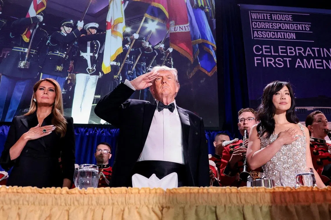 FILE PHOTO: U.S. President Donald Trump, with first lady Melania Trump and CBS News senior White House correspondent Weijia Jiang, salutes during the annual White House Correspondents' Association dinner in Washington, D.C., U.S., April 25, 2026. REUTERS/Jonathan Ernst/File Photo