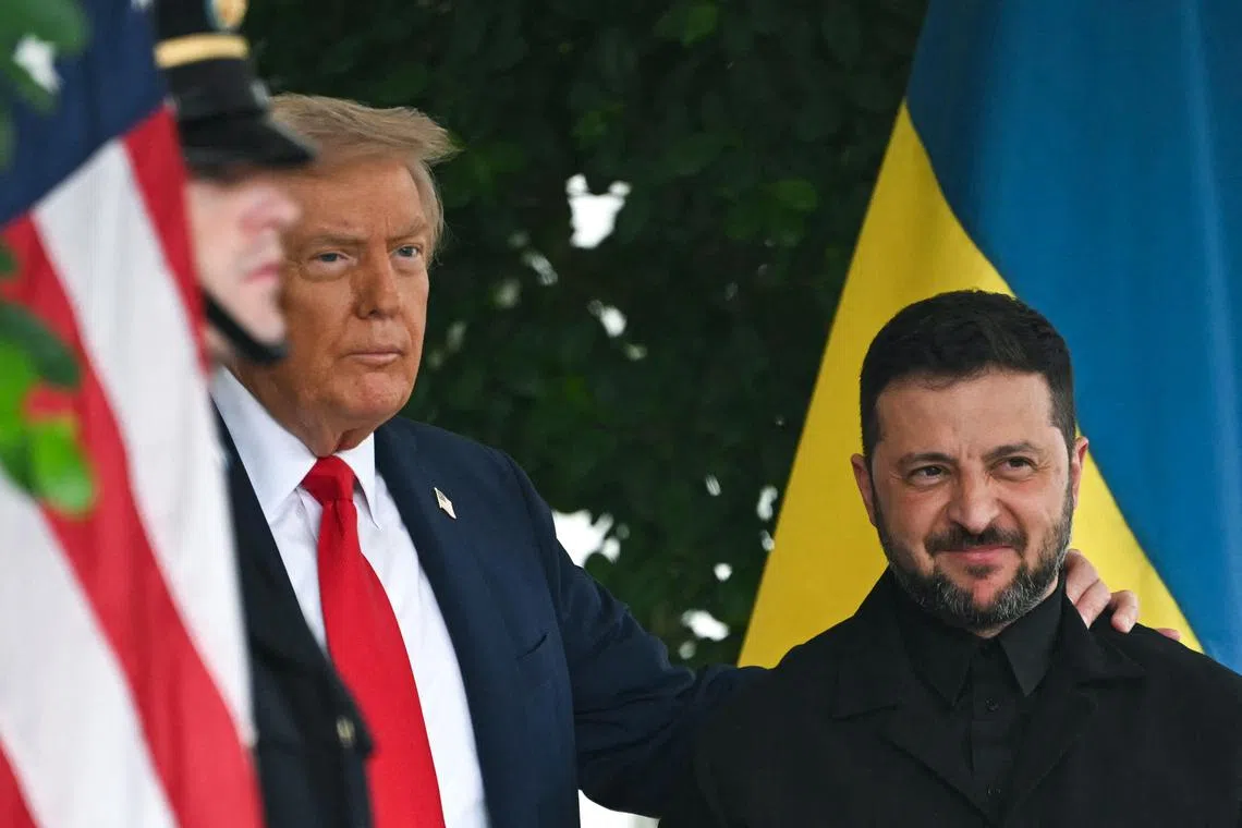Ukrainian President Volodymyr Zelensky (right) is welcomed to the White House by US President Donald Trump on Aug 18.