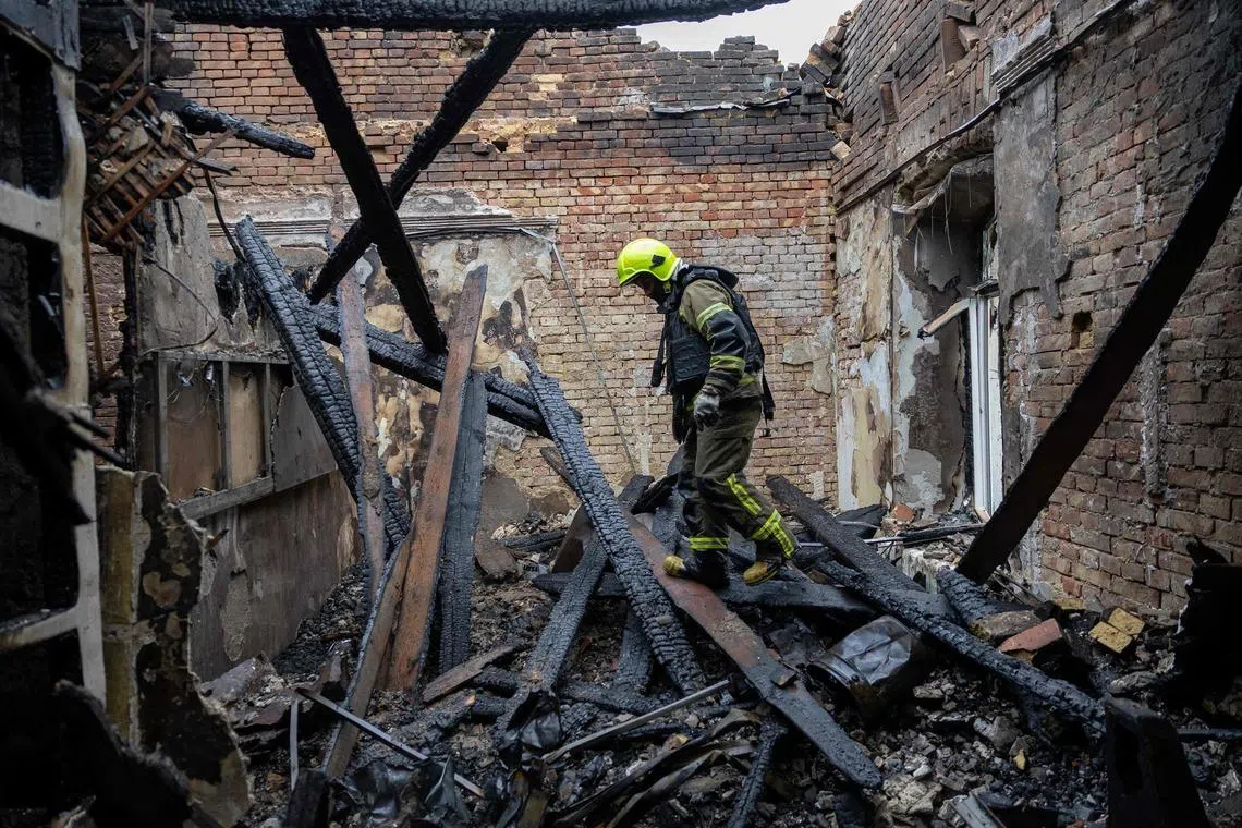 A Ukrainian rescuer at the site of an air attack in Odesa on May 18. Officials said Russia launched strikes at Ukraine overnight, hitting residential buildings, a school and a kindergarten in Odesa.