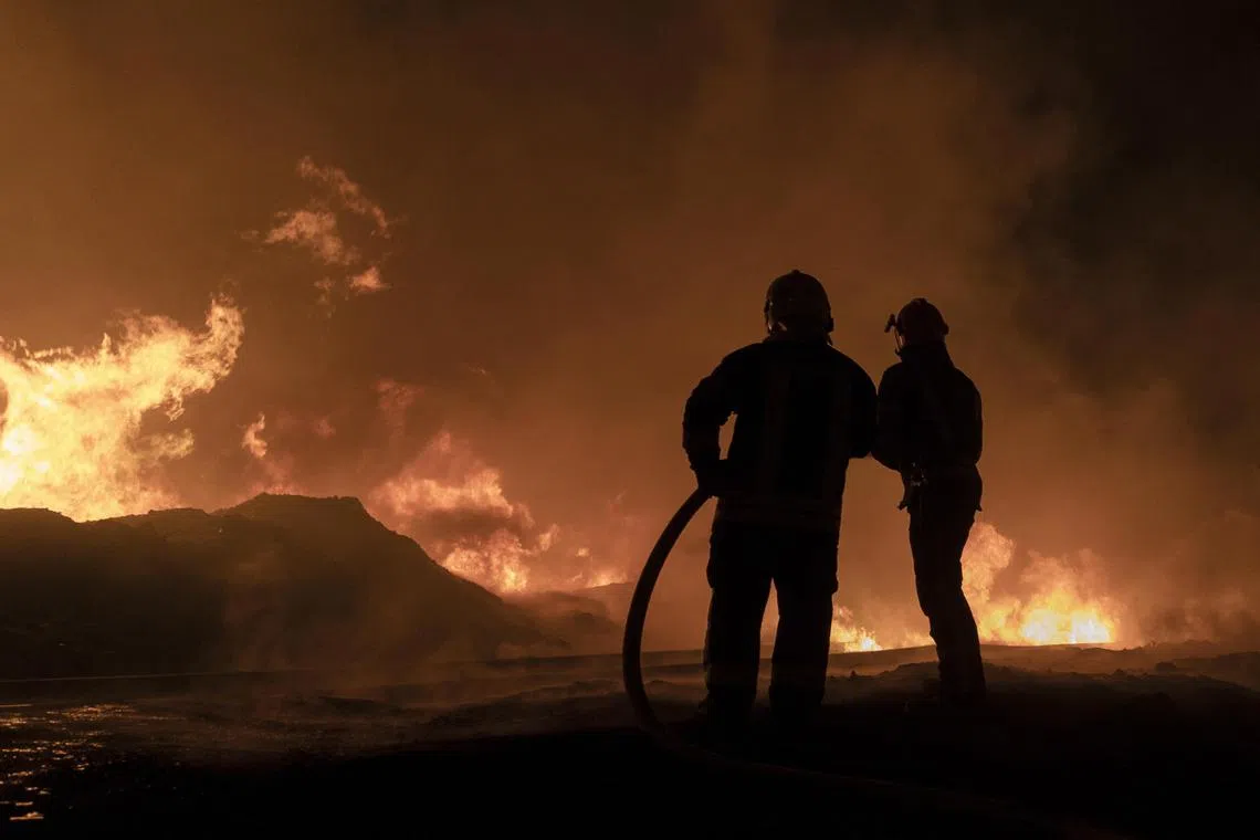 Rescue services work at the scene of a Russian drone strike in the eastern Ukrainian city of Kharkiv.