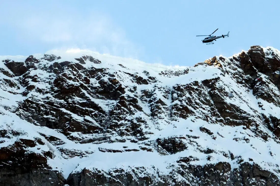 A helicopter helping to evacuate around 100 people stranded at high altitude, following the failure of the Macugnaga cable car in Verbania, in Italy's northwestern Piedmont region, on Dec 30.