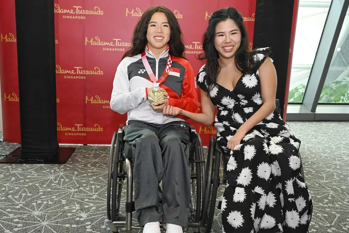 Yip Pin Xiu posing with Madame Tussaud's waxwork of her after the unveiling of the 2025 World Para Swimming Championships host city.