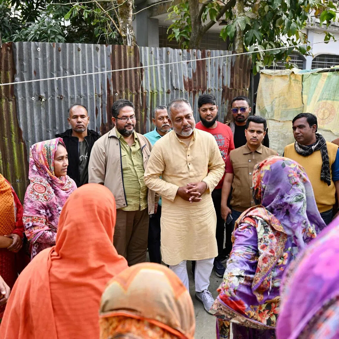 This photograph taken on Jan 14, 2026 shows Bangladesh Nationalist Party (BNP)'s election candidate SM Zilany (centre) speaking with residents during a visit to his electoral constituency Gopalganj.