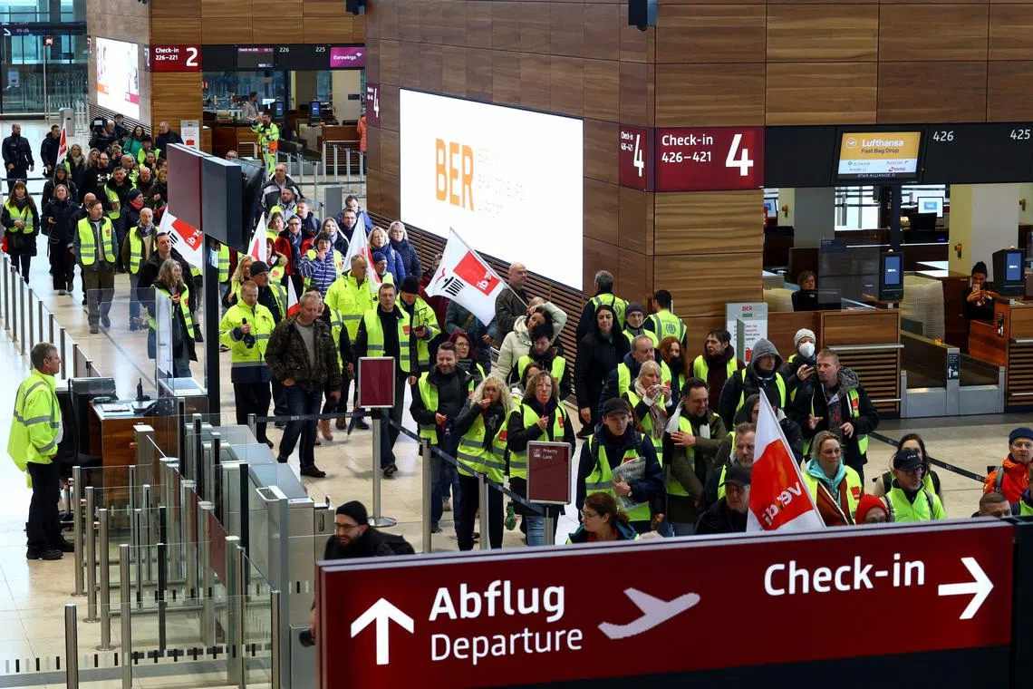 Airport workers protest during a strike at the airport in Berlin, Germany, on March 13, 2023. 