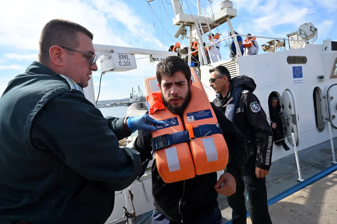 Crew members from a ship damaged in a drone attack disembark from a Bulgarian border police vessel in Varna, Bulgaria, following a rescue operation after one vessel was sunk and another damaged in the Black Sea off Bulgaria, October 6, 2026. REUTERS/Petko Momchilov