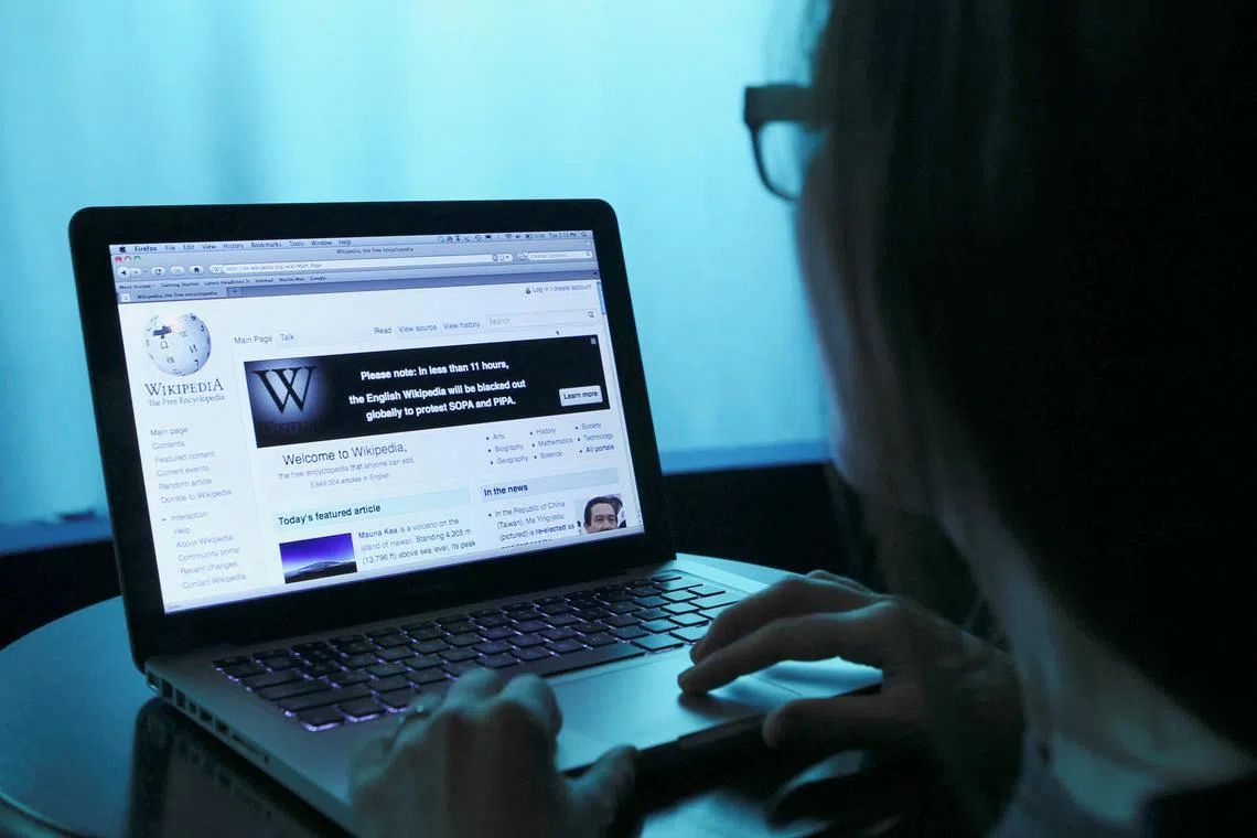 FILE PHOTO: Wikipedia webpage in use on a laptop computer is seen in this photo illustration taken in Washington, January 17, 2012.      REUTERS/Gary Cameron/File Photo