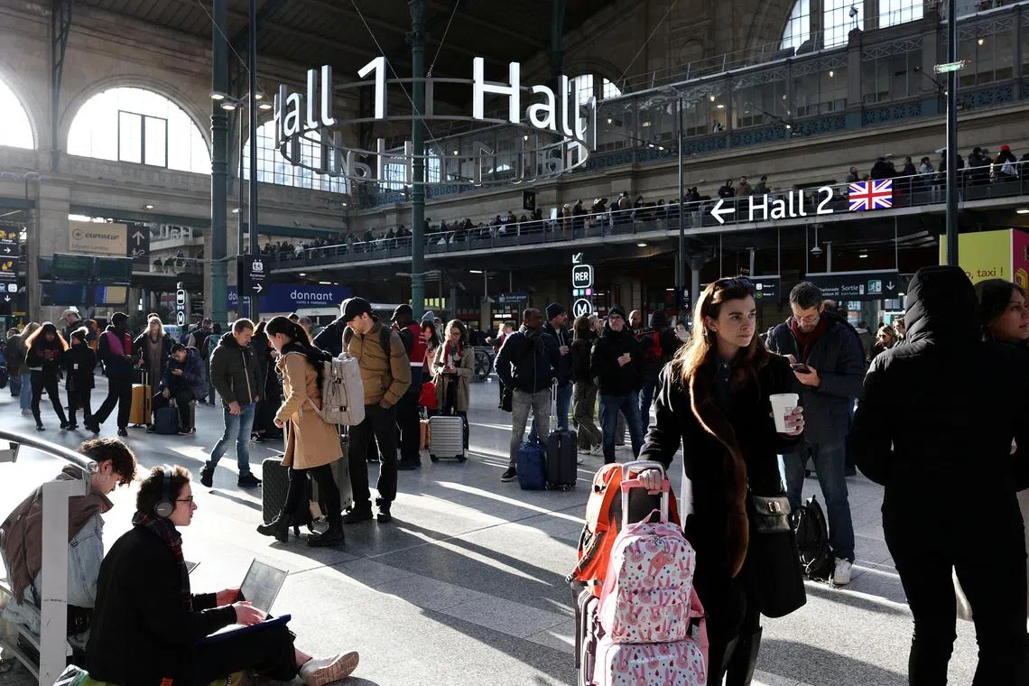 Passengers wait inside the departure hall at the Paris Gare du Nord train station following the discovery of an unexploded bomb, on March 7, 2025.
