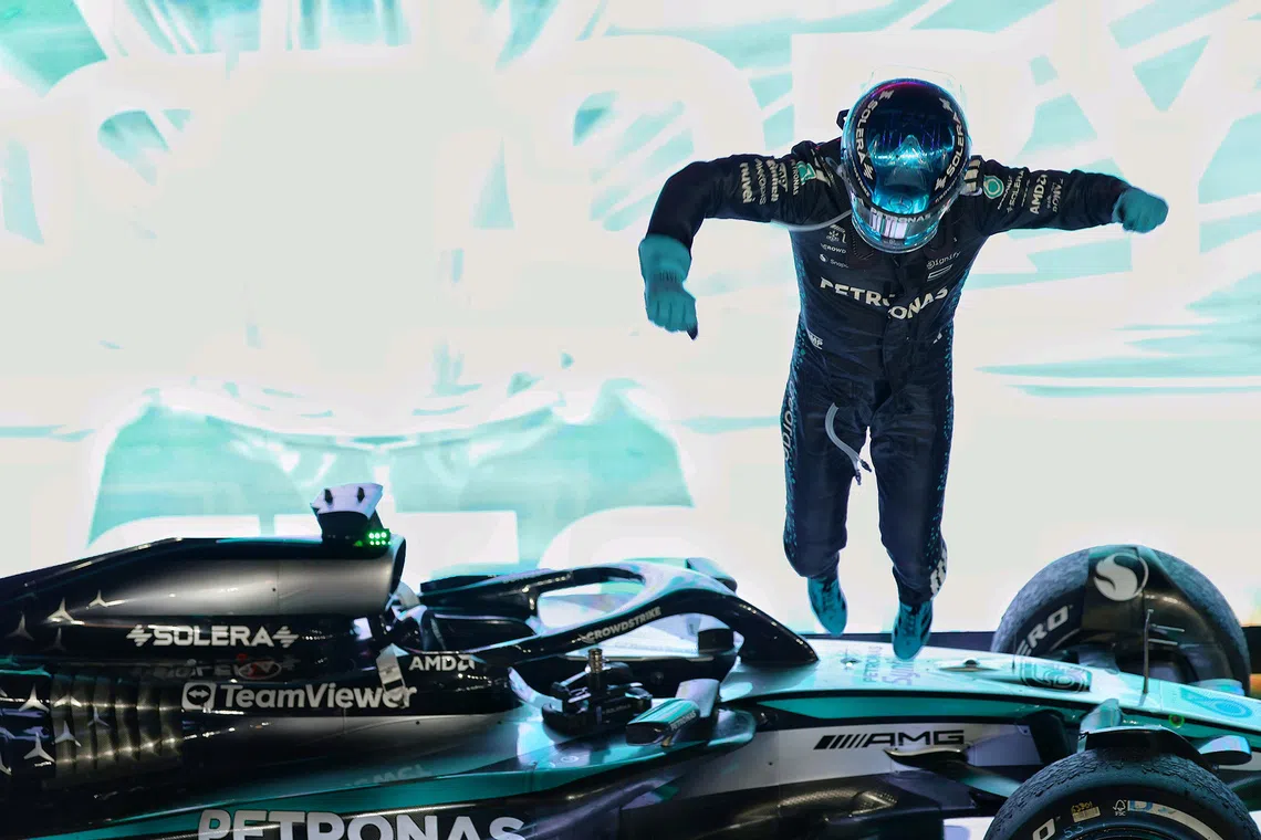 Mercedes' George Russell jumping off his car after winning the 2025 Formula One Singapore Airlines Singapore Grand Prix at the Marina Bay Street Circuit on Oct 5, 2025. 