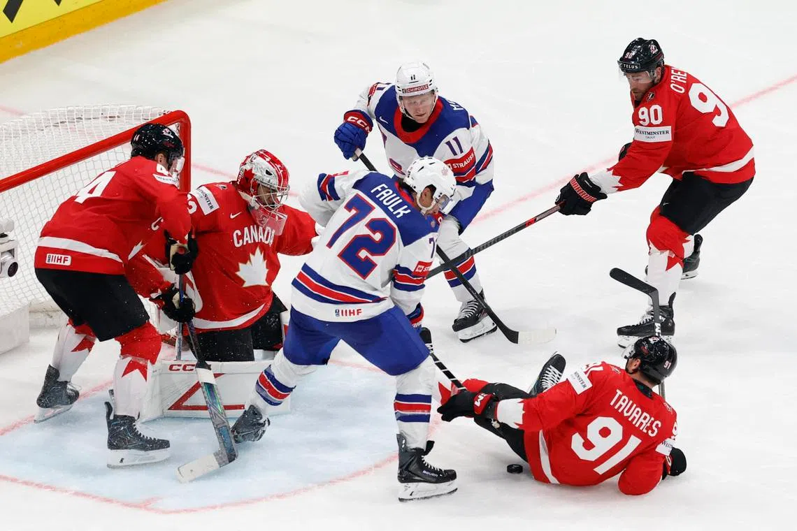 Ice Hockey - IIHF World Championships - Quarter Final - Canada v United States - BCF Arena, Fribourg, Switzerland - May 28, 2026 Justin Faulk and Oliver Moore of the U.S. in action with Canada's Morgan Rielly, John Tavares and Ryan O'Reilly REUTERS/David W Cerny