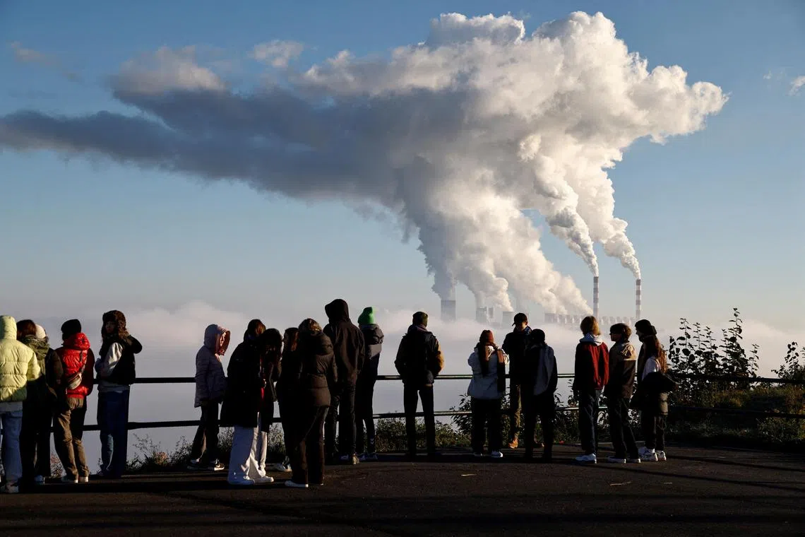 FILE PHOTO: People watch smoke and steam billow from Belchatow Power Station, Europe's largest coal-fired power plant powered by lignite, in Zlobnica, Poland October 20, 2022. REUTERS/Kuba Stezycki/File Photo
