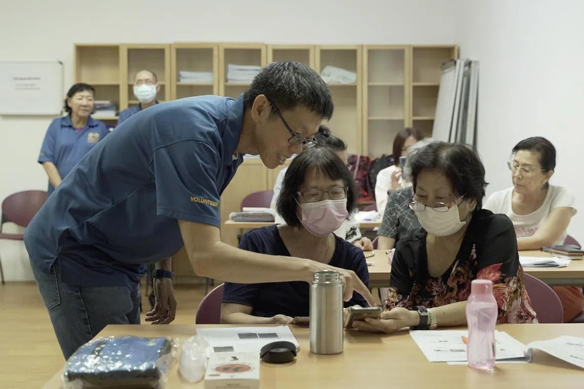 Seniors participating in a digital photo editing class offered by the National Silver Academy and organised by RSVP Singapore in July 2023.