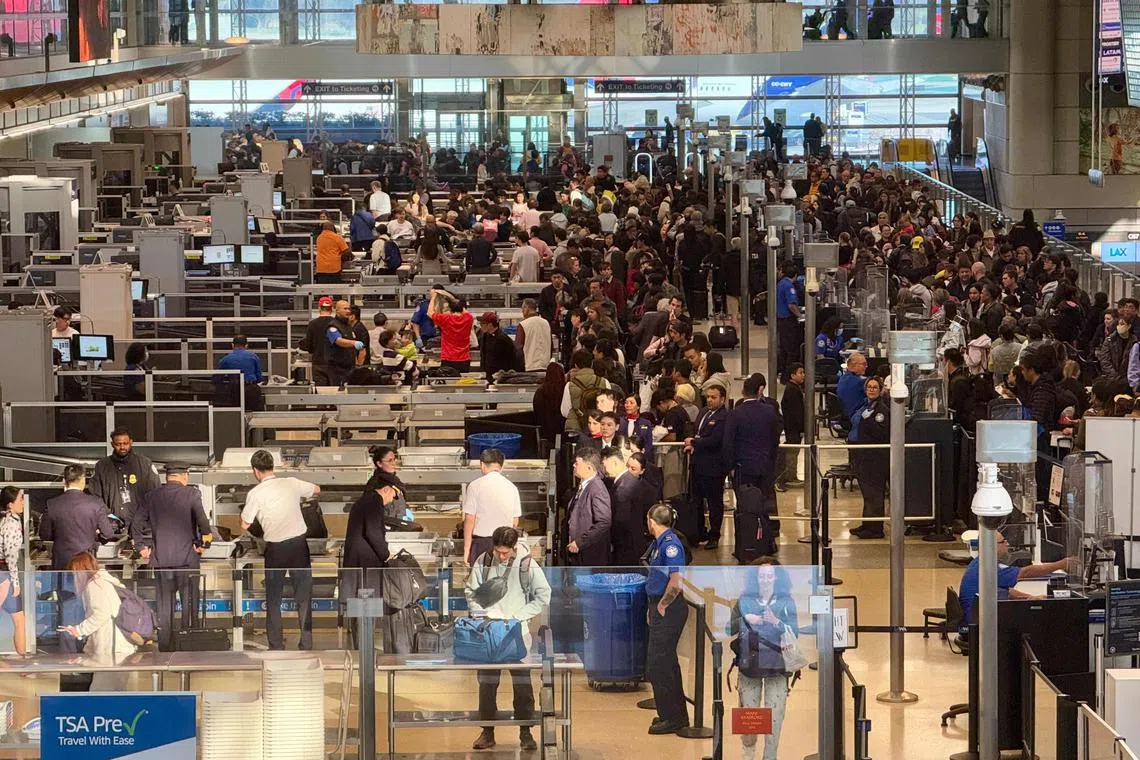 People line up to enter TSA checkpoints in Los Angeles International Airport (LAX), located in Southern California, on January 6, 2025.  (Photo by Daniel SLIM / AFP)