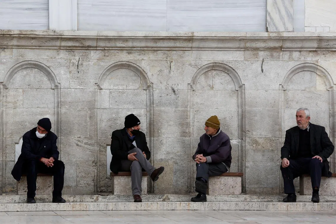 FILE PHOTO: Men rest at the courtyard of Fatih Mosque in Istanbul, Turkey April 7, 2023. REUTERS/Dilara Senkaya/File Photo