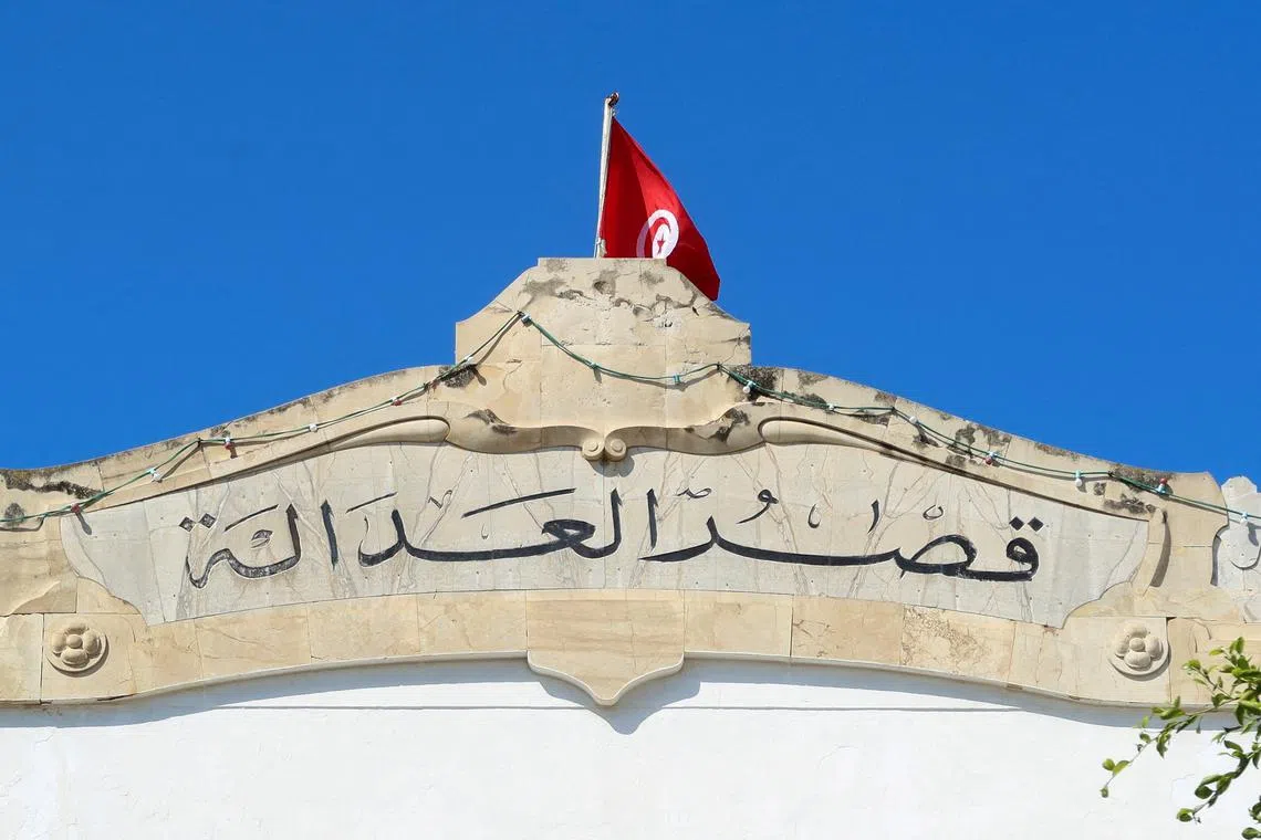 FILE PHOTO: A Tunisian flag flutters atop the Palace of Justice building in Tunis, Tunisia May 13, 2024. REUTERS/Jihed Abidellaoui/File Photo