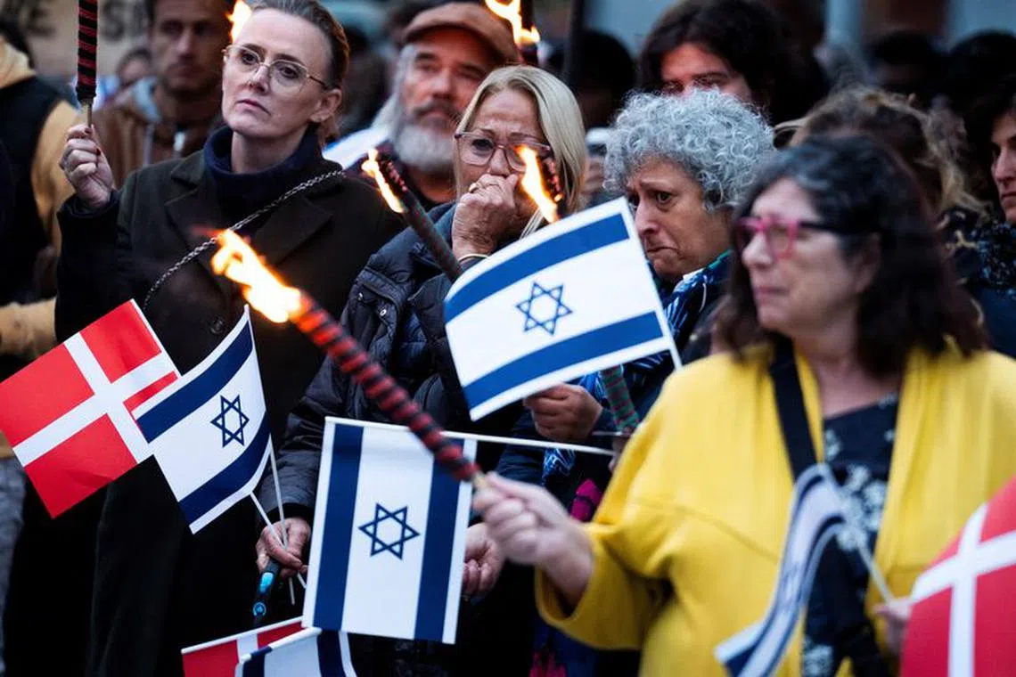 People hold flags during "Solidarity with Israel" demonstration organised by Jewish Youth, Danish Zionist Federation, KU and DSU at Israels Plads in Denmark.