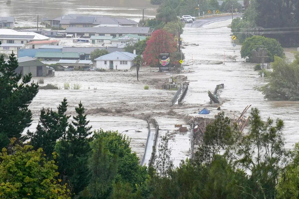 An aerial photo shows the Waiohiki bridge and surrounding area inundated by the Tutaekuri River after Cyclone Gabrielle made landfall near the city of Napier, Feb 14, 2023. New Zealand declared a national state of emergency on Feb 14 as Cyclone Gabrielle swept away roads, inundated homes and left more than 100,000 people without power. 