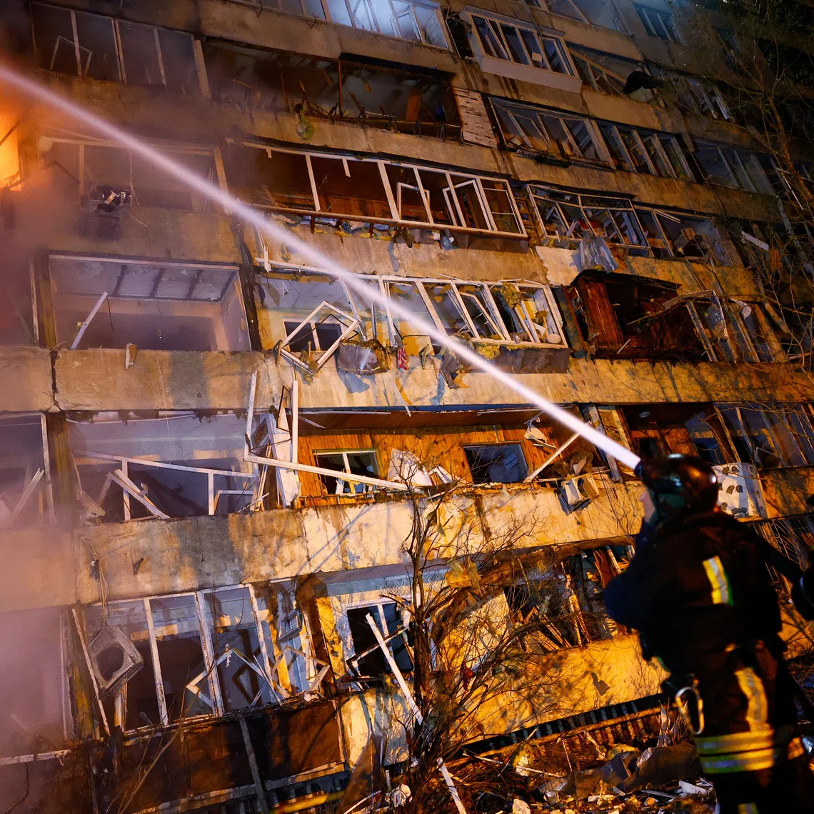 Firefighters work at the site of an apartment building damaged by a Russian missile strike, amid Russia's attack on Ukraine, in Kyiv, Ukraine October 13, 2026. REUTERS/Valentyn Ogirenko