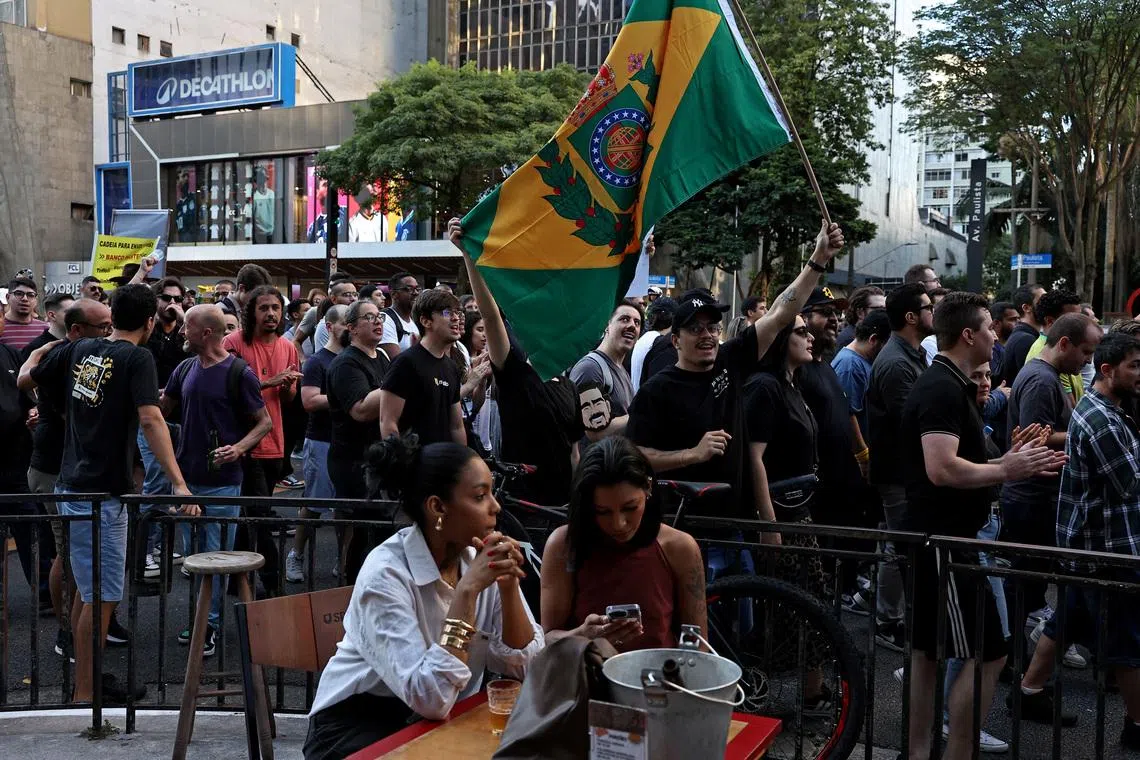 Demonstrators from the right-wing party Missao (Mission in english) and group Movimento Brasil Livre (MBL) hold a flag from the Brazil Monarchy during a protest against corruption and demanding harsher penalties for criminals, in Sao Paulo, Brazil.