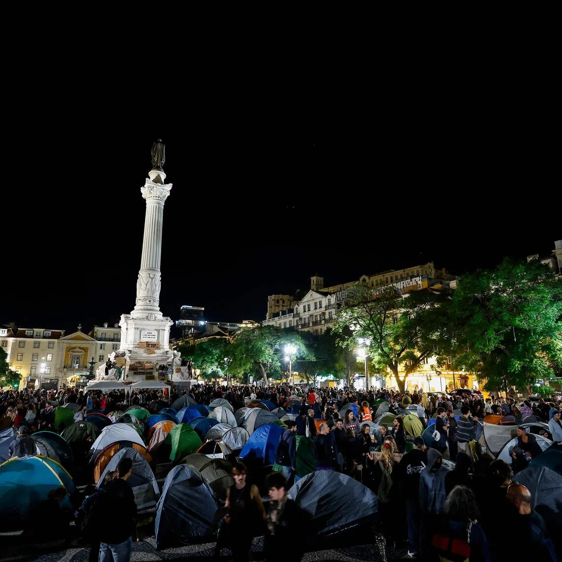Demonstrators set up tents to protest against housing shortage, soaring rents and low wages on Rossio square in central Lisbon on Oct 18.