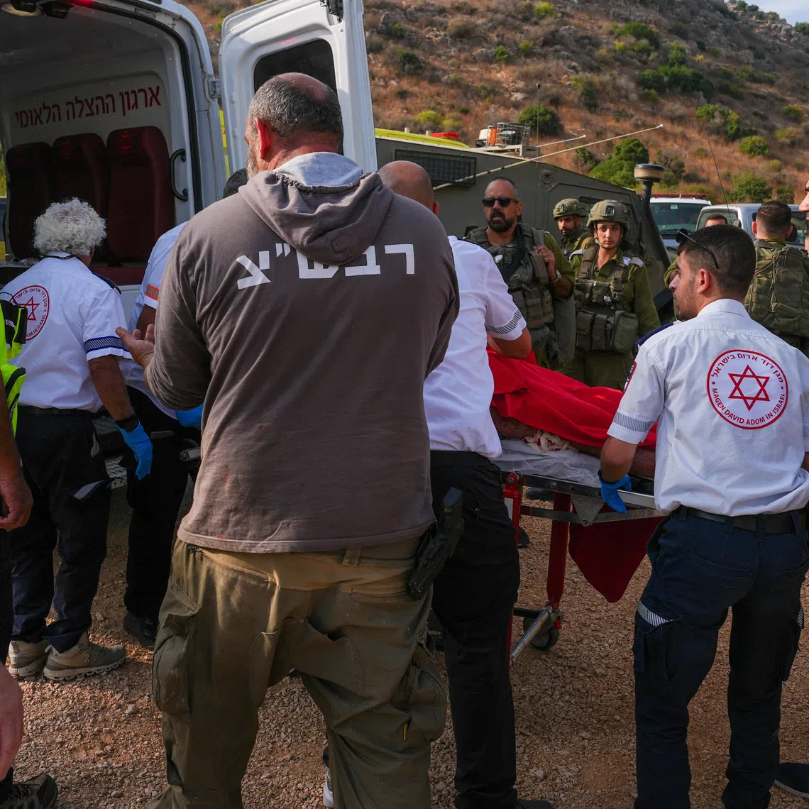 Israeli paramedics place a person on a stretcher in an ambulance, following an incident involving an explosion, near Kiryat Shmona, in northern Israel, October 12, 2026. REUTERS/Ayal Margolin
