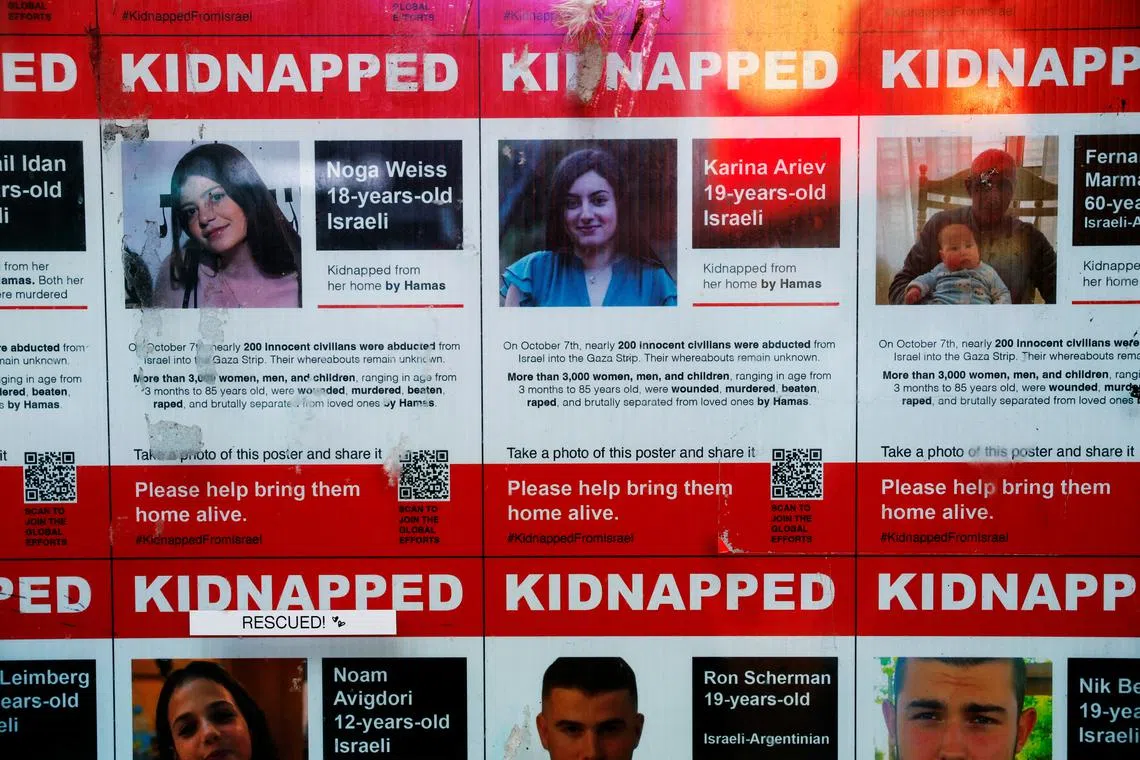 FILE PHOTO: Posters of hostages kidnapped during the deadly October 7, 2023 attack by Hamas on Israel are posted on a storefront window in the Times Square area of New York City, U.S., November 26, 2024. REUTERS/Shannon Stapleton/File Photo