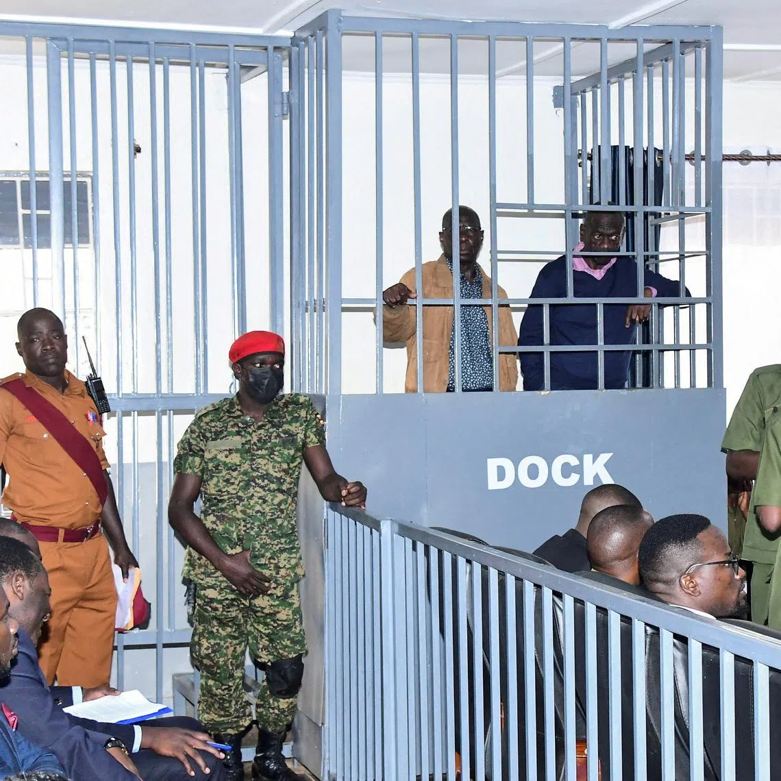 FILE PHOTO: Opposition leader Kizza Besigye and Obeid Lutale stand in a steel dock at the Uganda Military General Court Martial in Makindye, a suburb of Kampala, Uganda December 2, 2024. REUTERS Abubaker Lubowa/File Photo