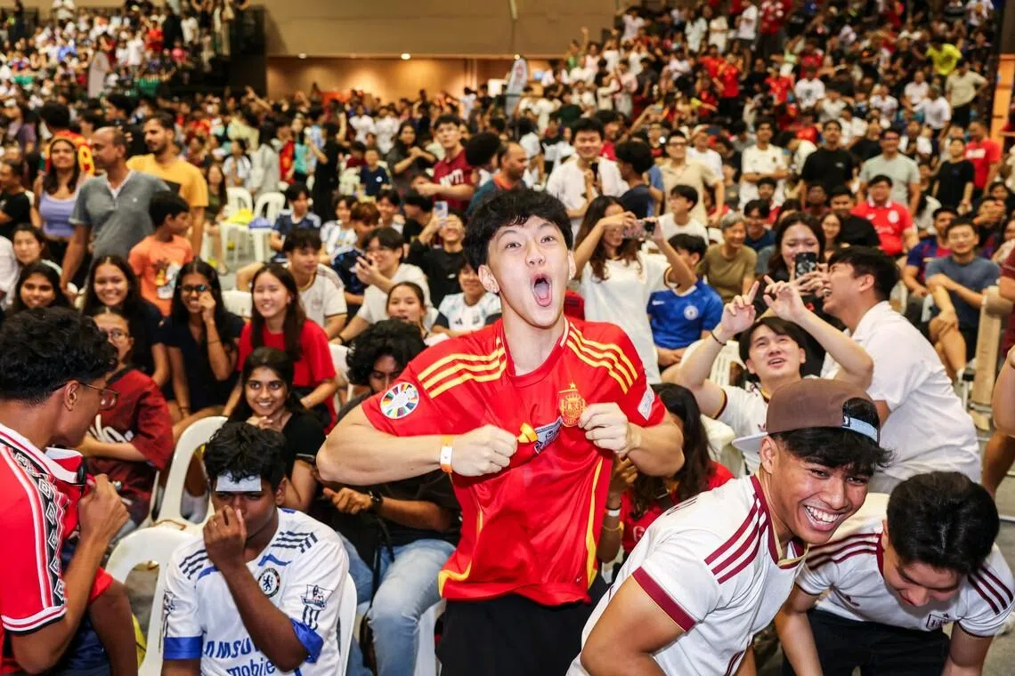 Fans celebrating Ferran Torres' goal during the live screening of the FIFA World Cup 2026 final between Argentina and Spain at Our Tampines Hub in the early hours of July 20, 2026. ST PHOTO: BRIAN TEO