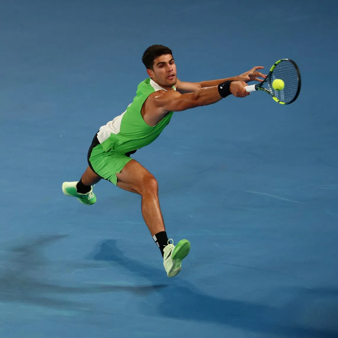Tennis - Australian Open - Melbourne Park, Melbourne, Australia - January 18, 2026 Spain's Carlos Alcaraz in action during his first round match against Australia's Adam Walton REUTERS/Tingshu Wang
