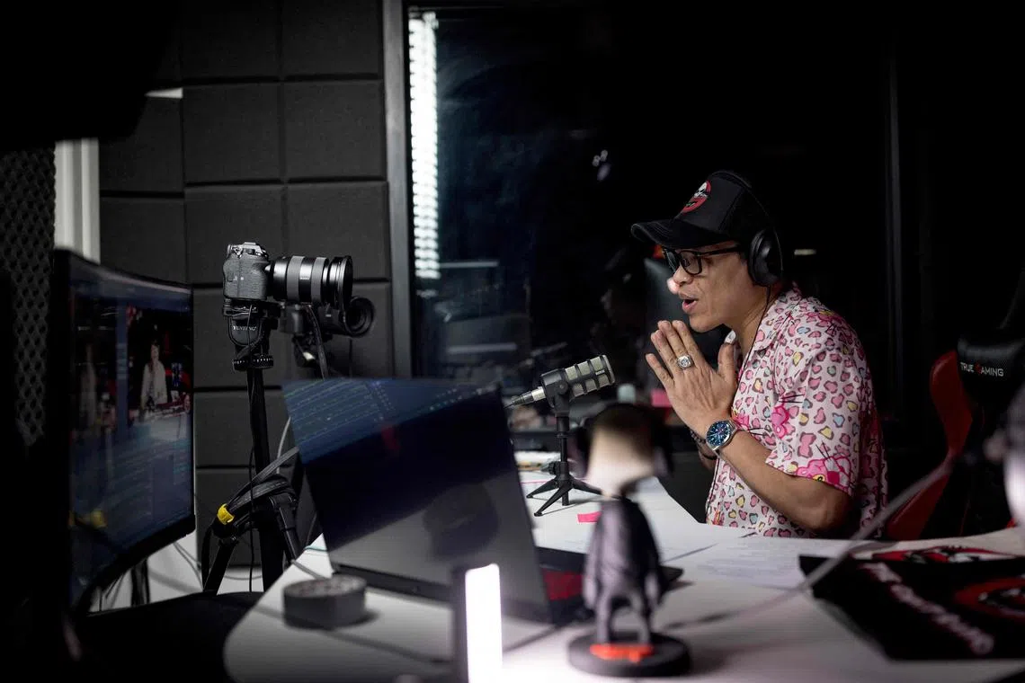 Ghost Radio station host Jack Watcharaphon greets the listeners as he broadcasts live from his studio in Bangkok.  