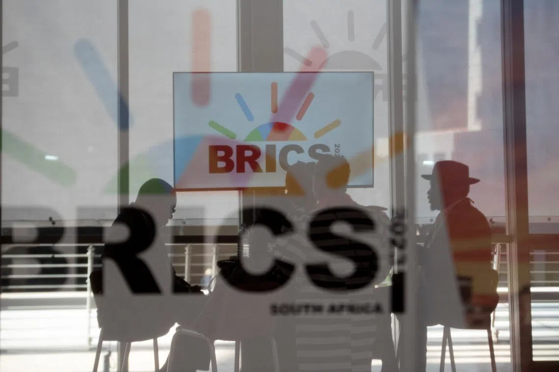 FILE PHOTO: South African delegates sit behind a glass with BRICS logo as the BRICS summit is held in Johannesburg, South Africa August 23, 2023. REUTERS/Alet Pretorius/File Photo