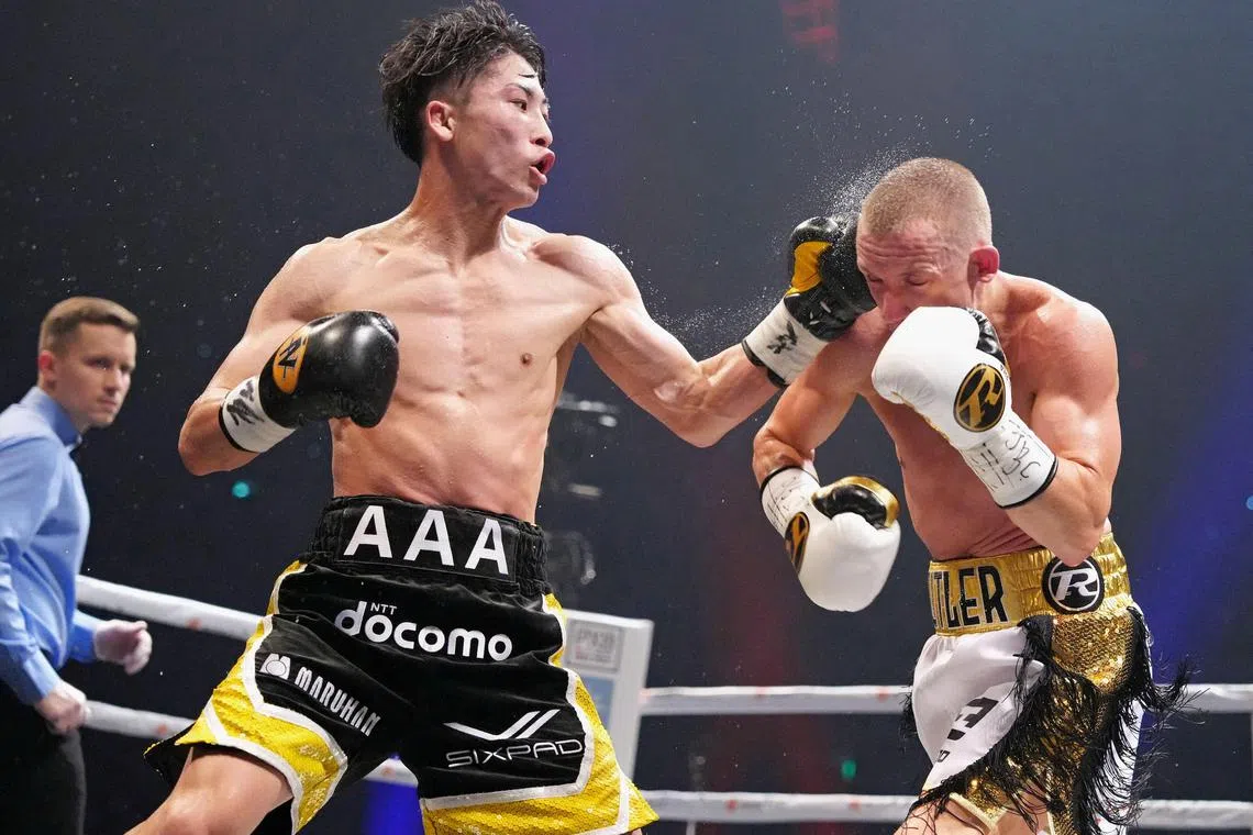 FILE PHOTO: Naoya Inoue of Japan throws a punch at Paul Butler of Britain during their bantamweight title unification boxing match of WBA, WBC, IBF and WBO in Tokyo, Japan, December 13, 2022, in this photo released by Kyodo. Kyodo via REUTERS/File Photo
