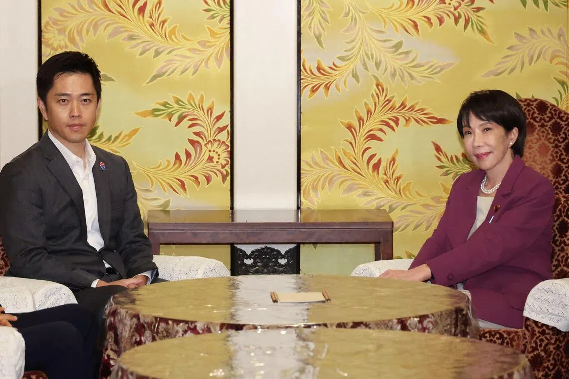 Liberal Democratic Party (LDP) president Sanae Takaichi (R) and co-leader of the opposition Japan Innovation Party Hirofumi Yoshimura meet in Tokyo on Oct 15.