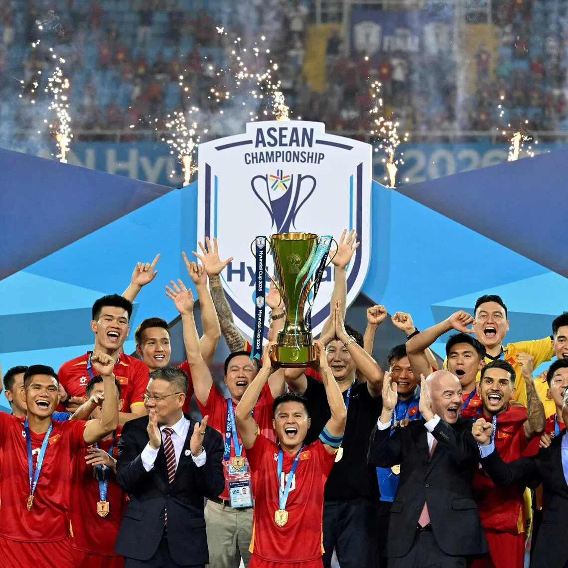 Vietnam’s players celebrate with the trophy after beating Thailand to win the ASEAN Championship Cup 2026.