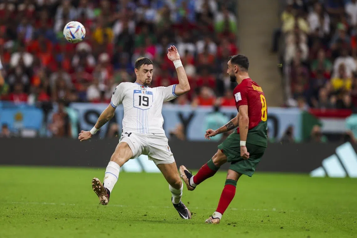 Bruno Fernandes (right) of Portugal in action against Sebastian Coates of Uruguay.