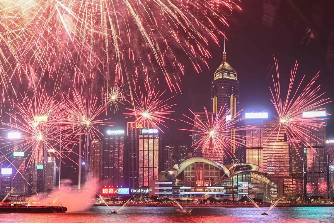 TOPSHOT - Fireworks light up over Victoria Harbour to commemorate China's National Day in Hong Kong on October 1, 2024. (Photo by Peter PARKS / AFP)