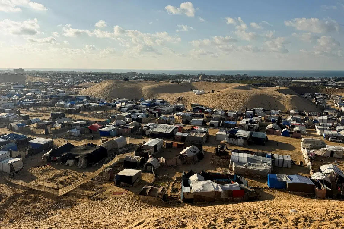 Displaced Palestinians shelter in a tent camp in Khan Younis, southern Gaza Strip on Dec 3.