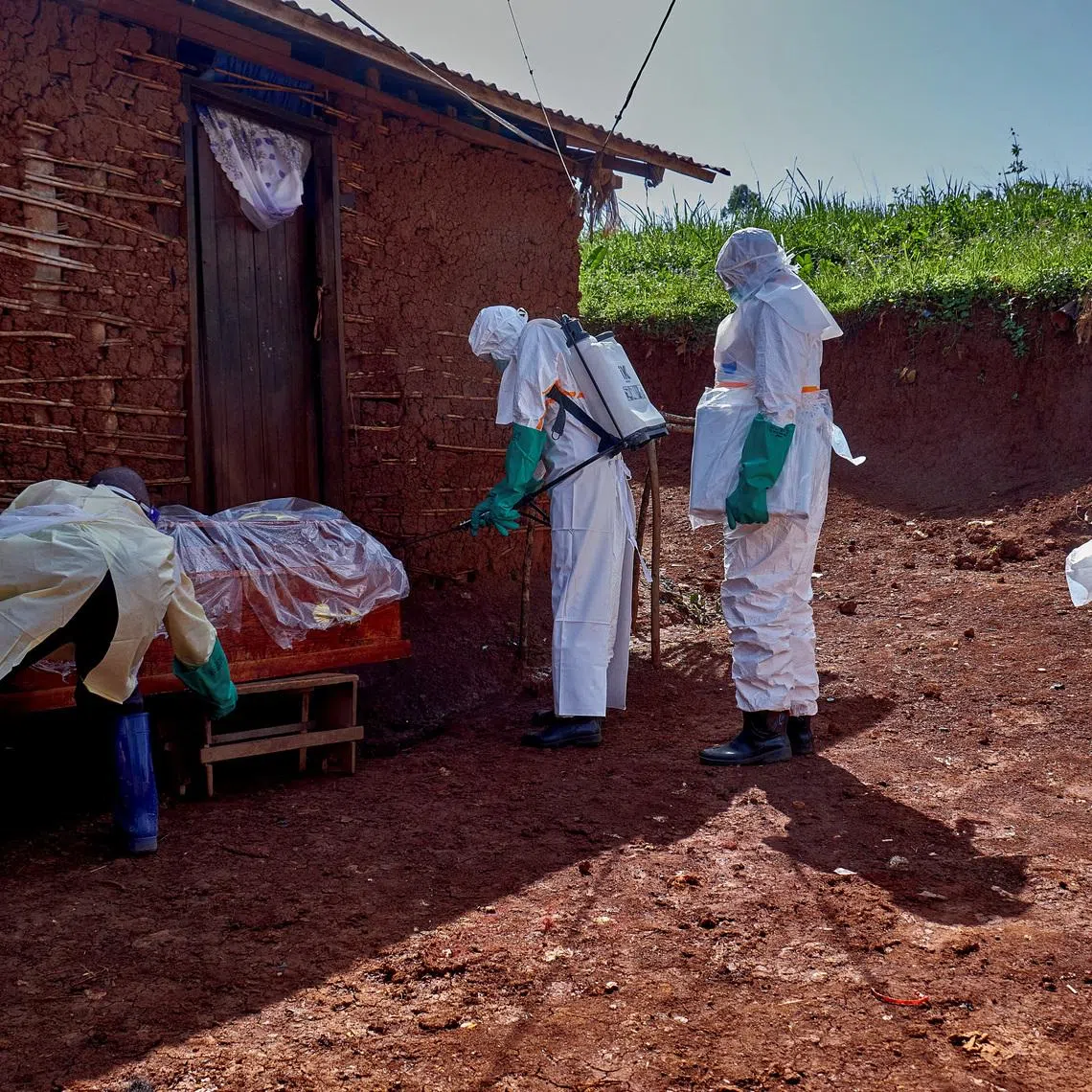 Red Cross workers wearing personal protective equipment as they disinfect the house of a man who died of Ebola, in Mongbwalu, Democratic Republic of the Congo, on May 24.