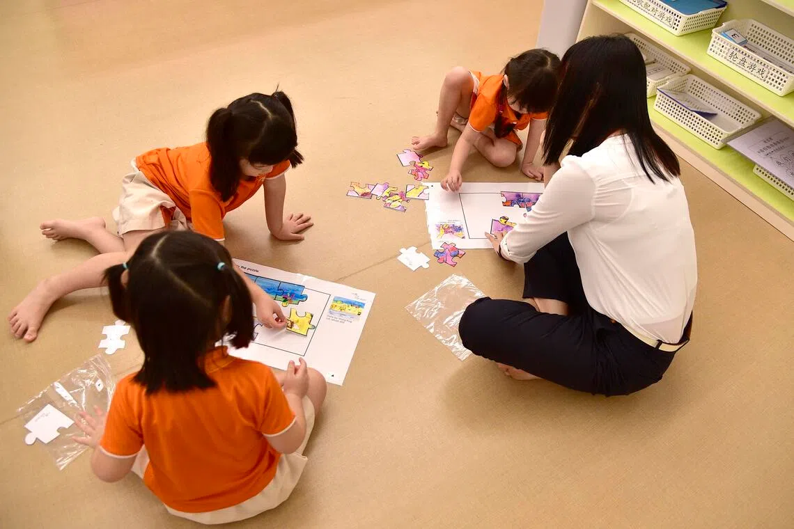 Preschoolers from NTUC My First Skool engaging in a jigsaw puzzle activity on 5 May 2017.
