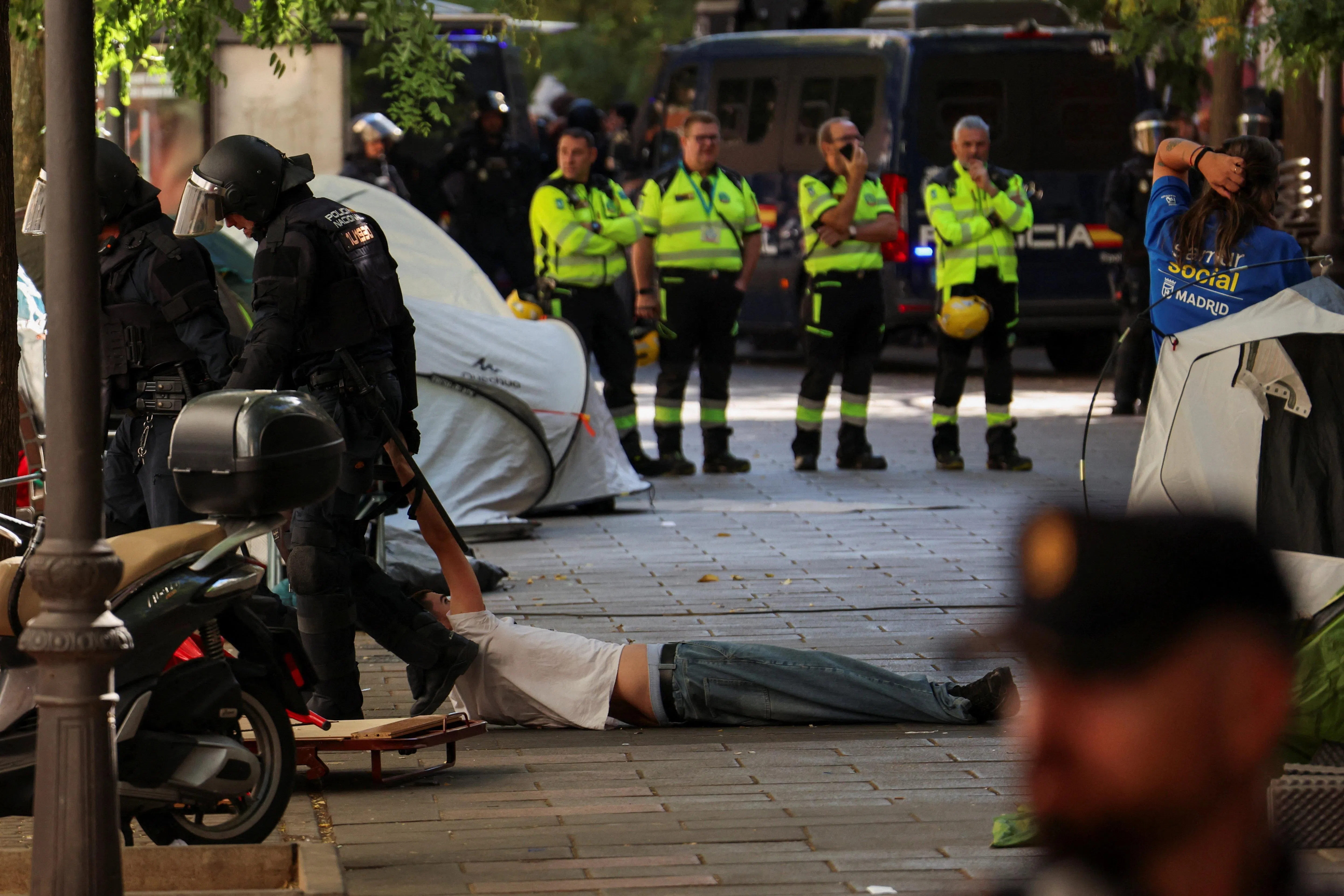 Spanish riot police removing a protester outside the home of Maricarmen Abascal, 87, during her eviction. She had lived at the property for 71 years, before it was acquired by an investment fund that sought a steep increase in her rent.