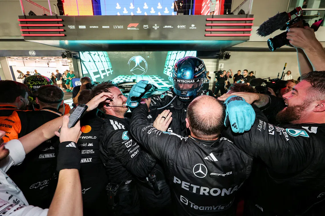 Mercedes' George Russell celebrating with his teammates after winning the 2025 Formula One Singapore Airlines Singapore Grand Prix at the Marina Bay Street Circuit on Oct 5, 2025. 
