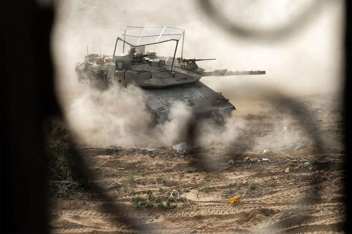 A handout picture released by the Israeli army on June 23, 2024 showing an Israeli army main battle tank operating in Rafah.